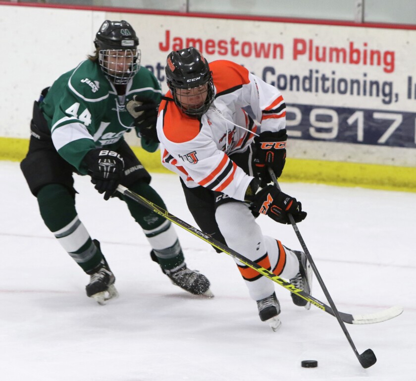 Bryson Yee carries the puck against Tyler Larson of Dakota College Bottineau on Friday at Wilson Arena. John M. Steiner / The Sun