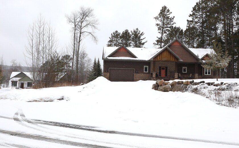 A home is under construction next to a completed home in a development near Giants Ridge in Biwabik