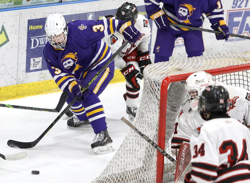 Cloquet-Esko-Carlton’s Joey Antonutti (3) tries to keep control of the puck behind the Duluth East goal