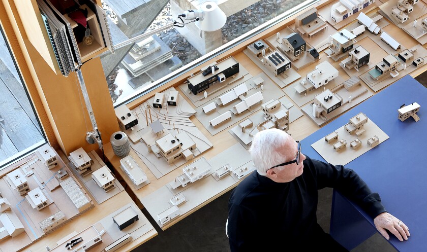 Architect talks near models.