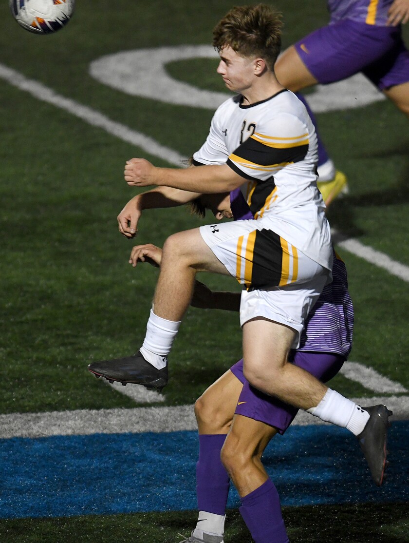 UW-Superior’s Freddy Watson (32) leaps by a Northwestern defender