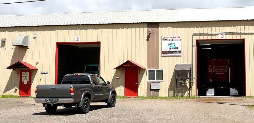Work goes on inside of Jeff Foster Collision Center in Superior