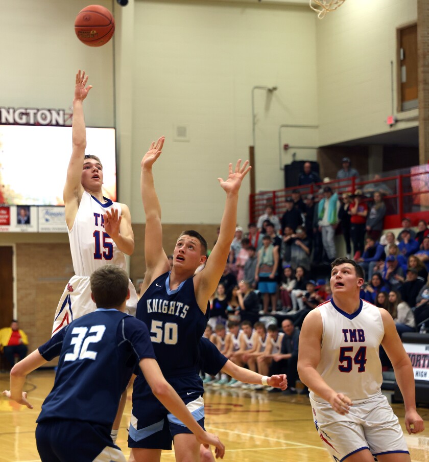 Tracy-Milroy-Balaton Panthers Trevor Smith (15) releases a shot over the heads of Russell-Tyler-Ruthton Knights defenders Dylan Anderson (32) and Drew Werkman(50) as teammate Tony Nelson (54) watches the play during Section 3A South boys basketball tournament play Thursday Night in Worthington.