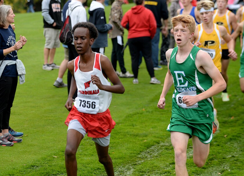 Willmar junior Fathi Dubet, 7356, runs ahead of Eagan's Patrick Barry at the Willmar Invitational on Saturday, Oct. 1, 2022 at Eagle Creek Golf Club in Willmar.