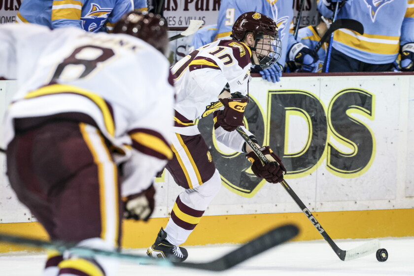 college men play ice hockey indoors