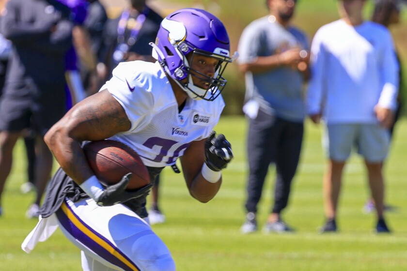 Professional football players practice at outdoor field