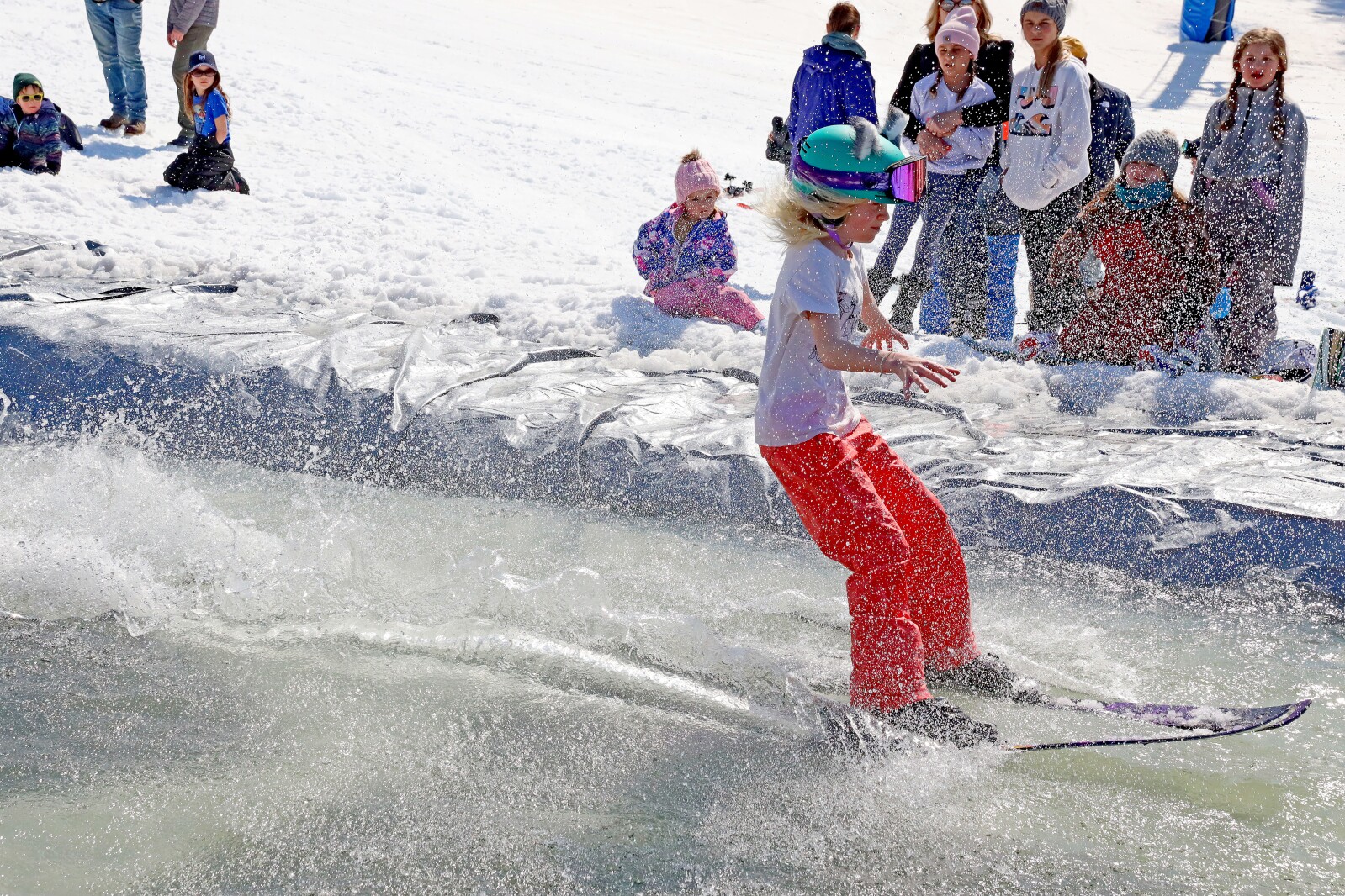 Skiers and snowboarders participate in the water skip at Mount Ski Gull on Saturday, April 8, 2023, for the end of the season.