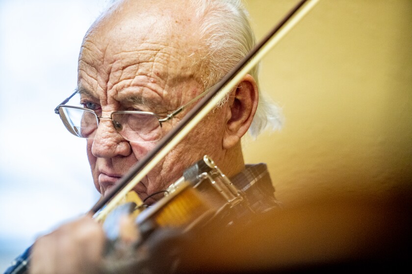 Don Schuck, of Willmar, practices playing his fiddle during the free workshop at Hope Lutheran Church on Sunday, April 3, 2022.