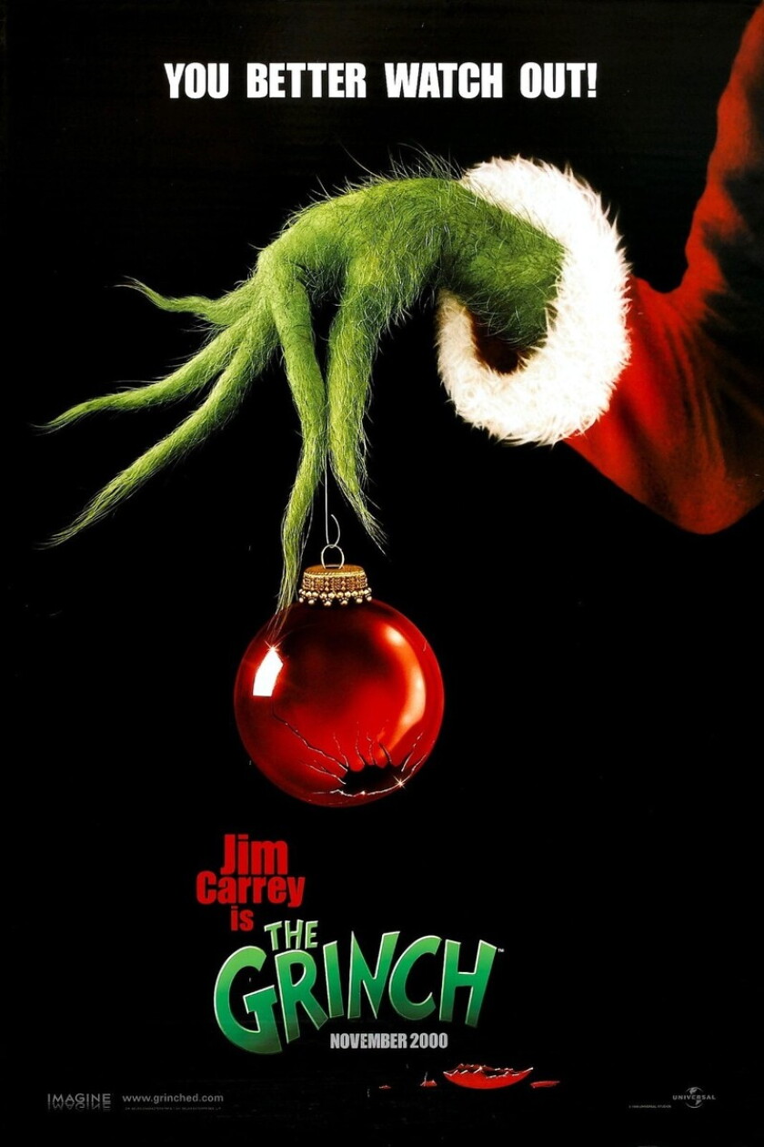 Cartaz de lançamento teatral de "Como o Grinch roubou o Natal." Mão verde peluda com dedos longos segura ornamento vermelho rachado contra fundo preto. O slogan diz, "é melhor você tomar cuidado."