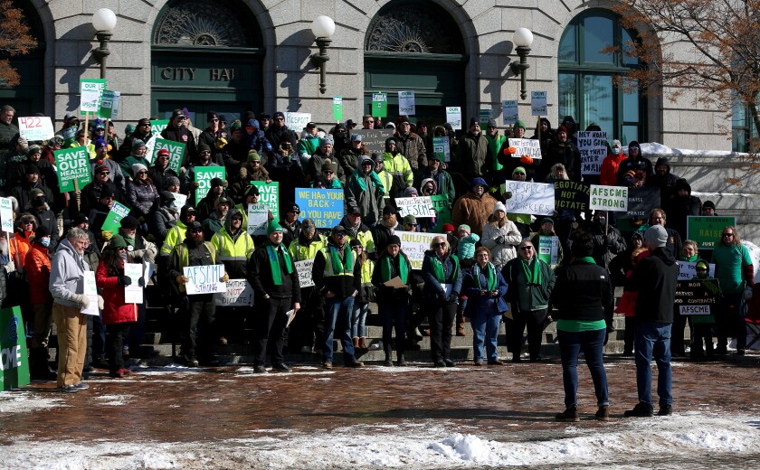 people standing on the steps of a rally