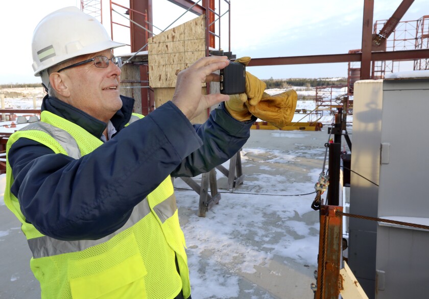 Tom Clarke takes a picture of what will be the Mesabi Metallics plant’s pelletizing building near Nashwauk recently. Steve Kuchera / skuchera@duluthnews.com