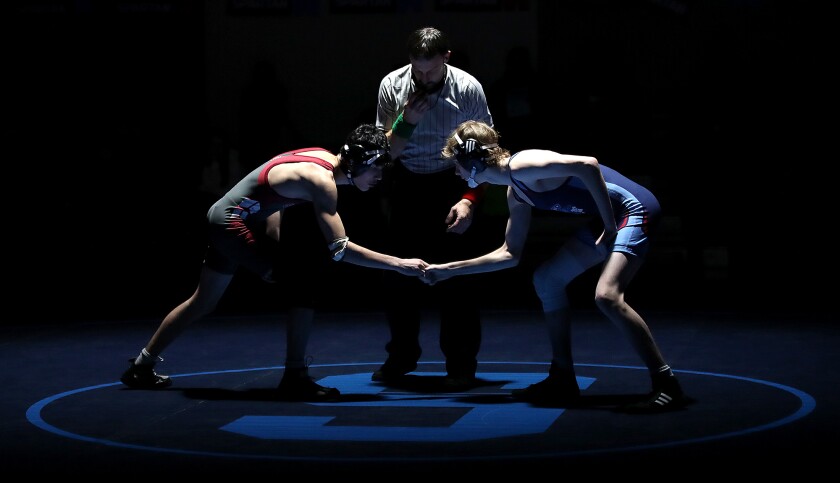 Spooner’s Michael Skodowski shakes hands with Superior’s Fjeordi Johnson before their match at 120 pounds