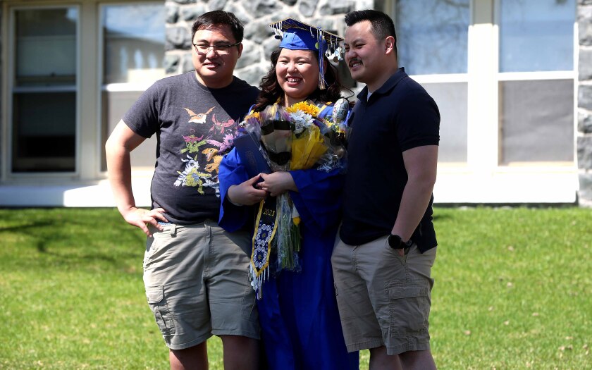 Graduate and her two brothers pose