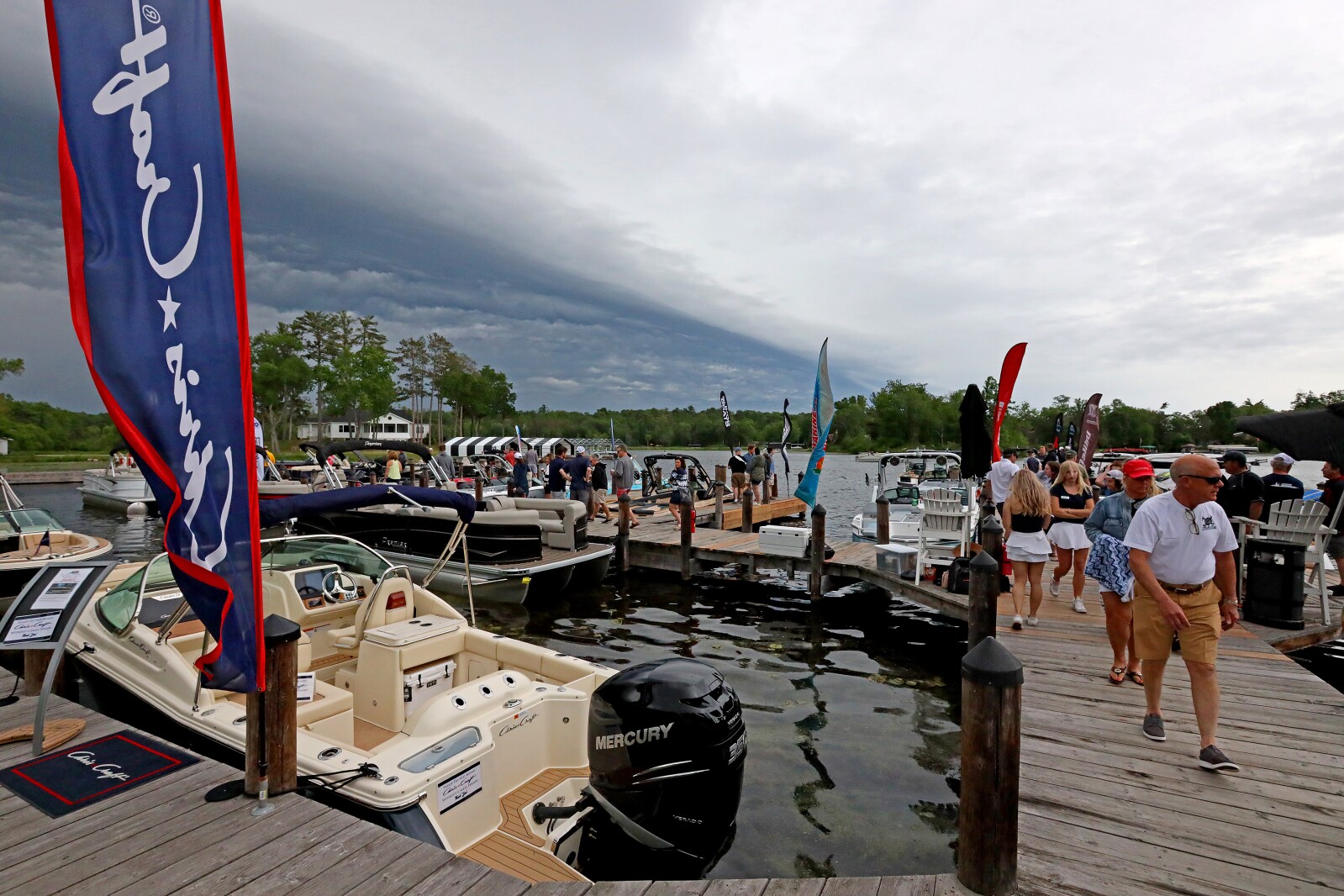 People gather for the ninth annual Bar Harbor In-Water Boat Show on Saturday, June 18, 2022, with boats from Nisswa Marine and Minnesota Inboard Water Sports at the Bar Harbor Supper Club on Gull Lake.