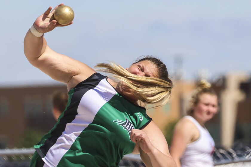 High school athletes compete in track and field events at outdoor stadium