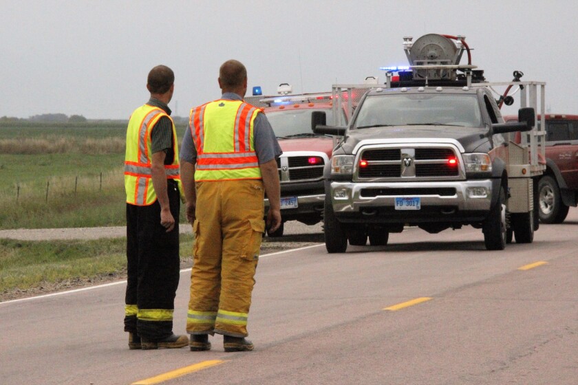 Members of the Corsica Fire Department block off the scene of a crash Wednesday on Highway 44 near Dakota Christian School, about four miles southwest of New Holland. (Jake Shama/Republic)