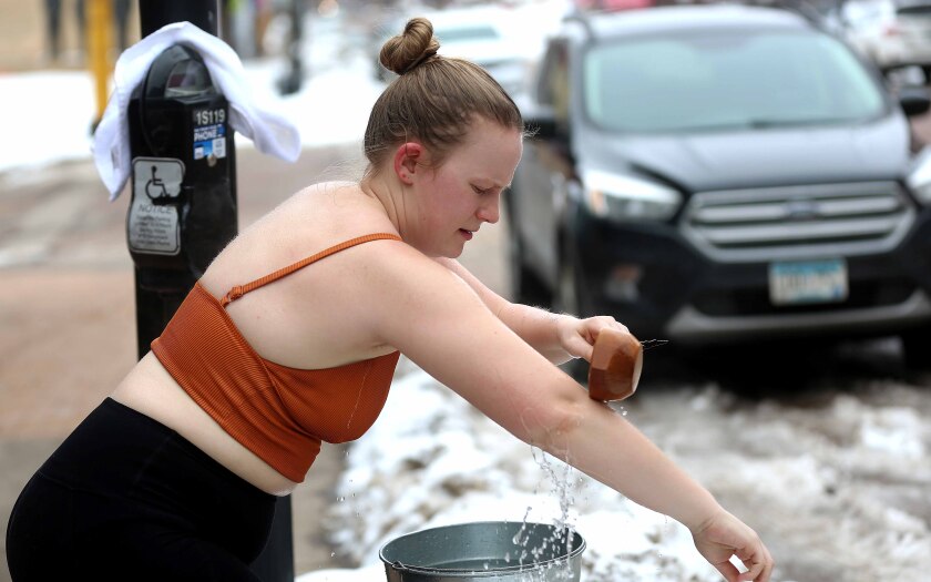 Woman pouring cold water on her arm