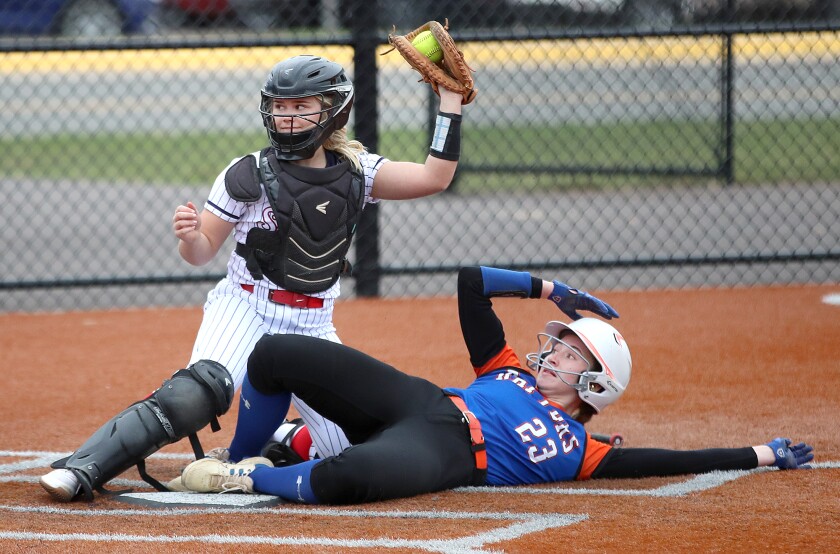 Catcher looks up after tagging out player at home plate.