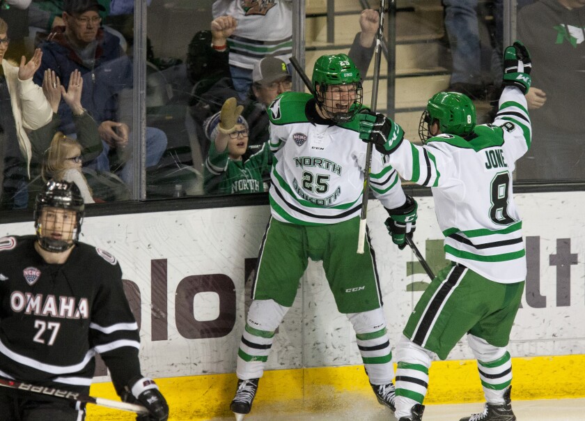 UND's Joel Janatuinen (#25) and Nick Jones (#8) celebrate a goal during Saturday's win over Omaha at the Ralph Engelstad Arena. Nick Nelson / Grand Forks Herald