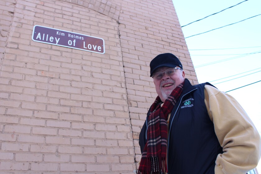 Kim Holmes, former owner of Grand Forks' downtown restaurant Sanders 1907, stands Thursday in the Alley of Love, an alley behind his restaurant known for attracting lovers. Holmes now enjoys retirement with his wife, Beth. (April Baumgarten/Grand Forks Herald)