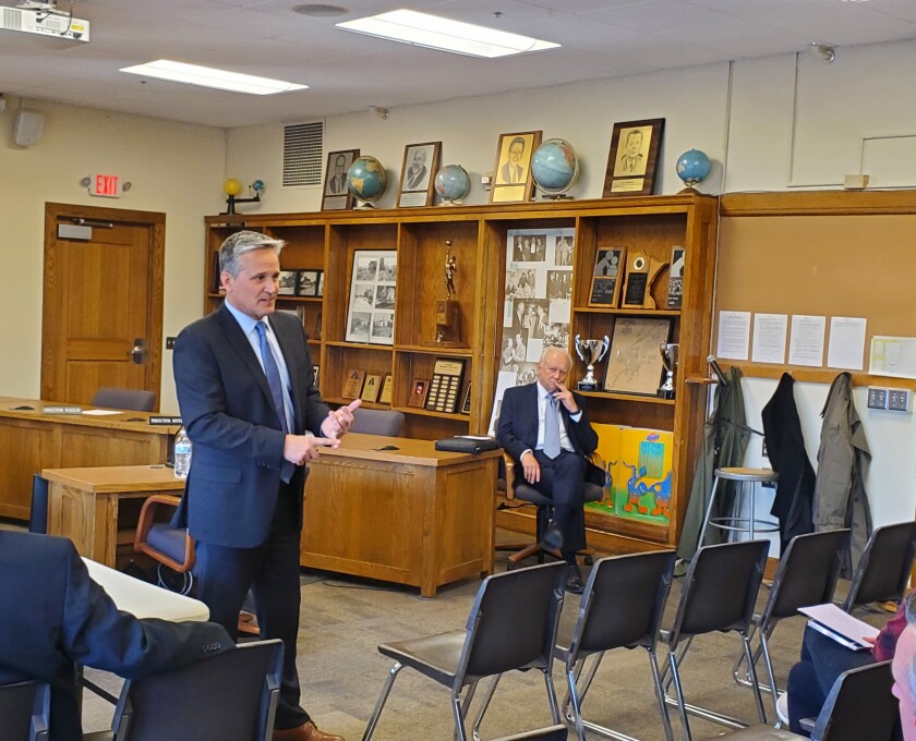 Eric Schneider speaks in front of a group of people