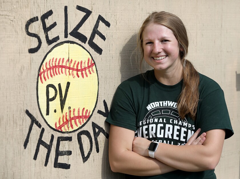 Northwood/Solon Springs’ Zoey Vaara stands next to the painting on the team’s dugout in memory of her father, Paul Vaara