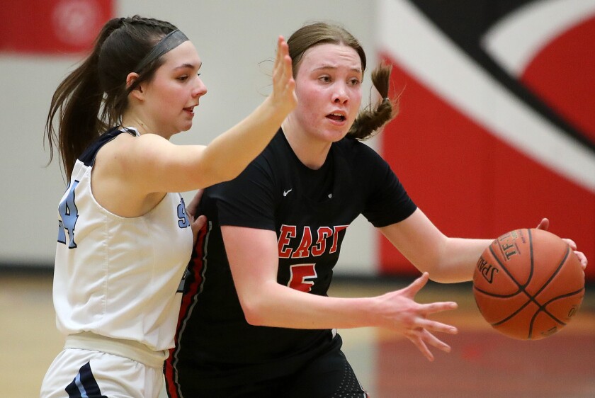 Duluth East’s Ashlynne Guenther (5) tries to get past the pressure put on by Superior’s Ava Stratton (24)