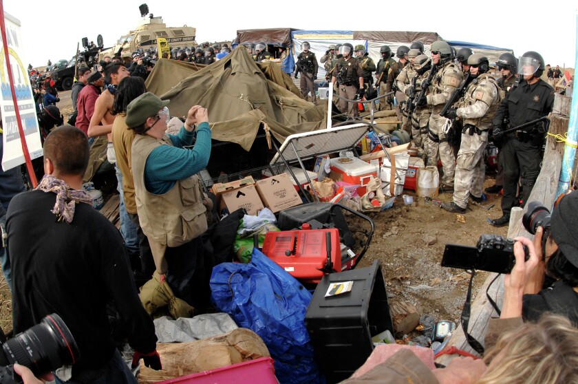 Hundreds of Dakota Access Pipeline protesters clashed with law enforcement as they were forced from the Front Line Camp located on DAPL land to the Oceti Wakoni overflow camp a few miles down the road on Highway 1806 in Morton County on Oct. 27. Bismarck Tribune file photo.