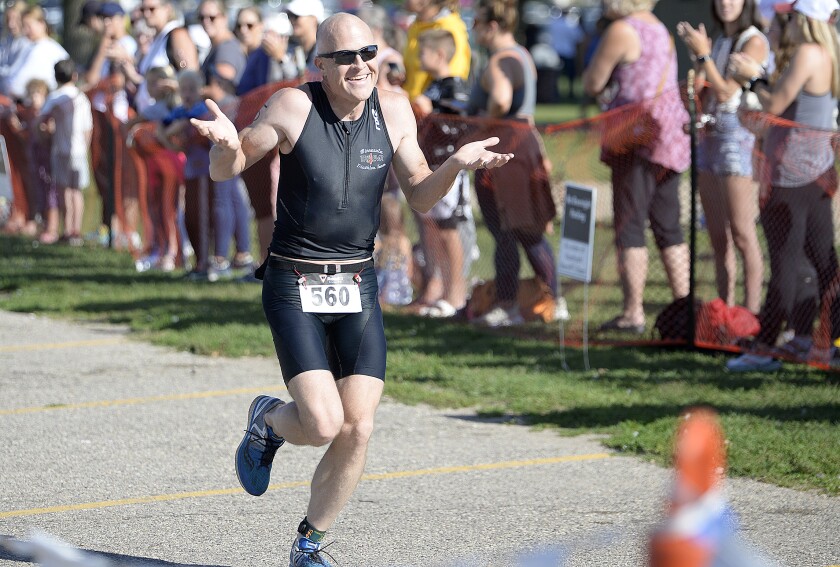 Benson's William Lorenz shrugs and laughs as he nears the finish line during the three-mile run in the Green Lake Triathlon on Sunday, Aug. 14, 2022 at Spicer.