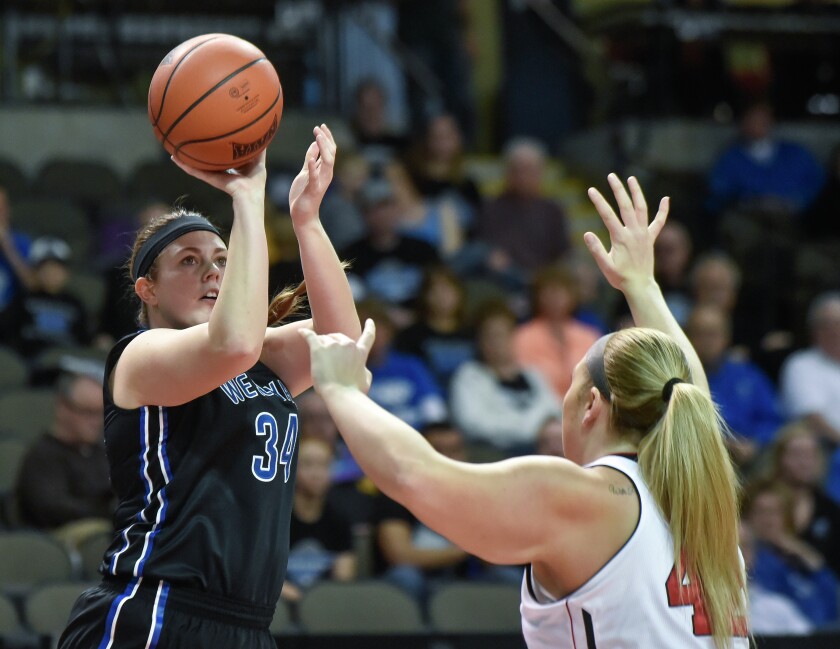 Dakota Wesleyan's Kristin Sabers (34) shoots over Davenport University's Mallory Sewell (42) during the second round of the NAIA Division II women's national tournament on Friday morning at the Tyson Events Center in Sioux City, Iowa. (Matt Gade/Republic)