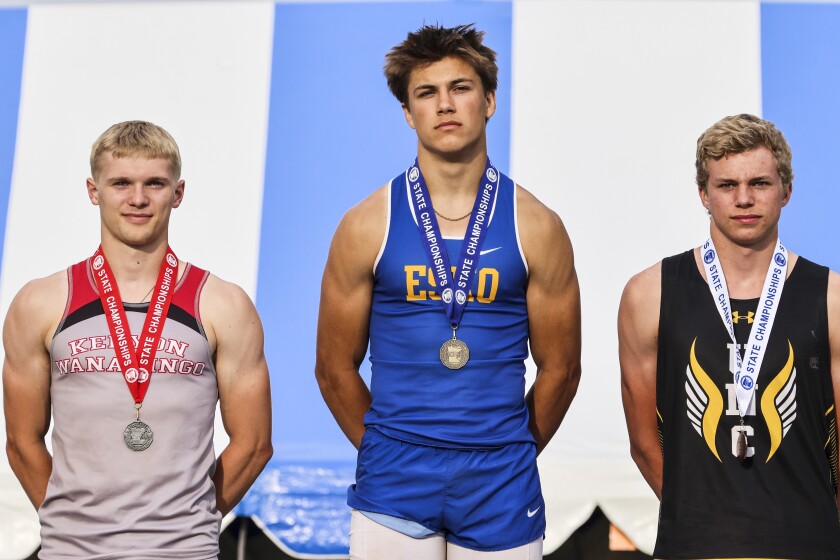 Athletes compete in track and field events at outdoor stadium