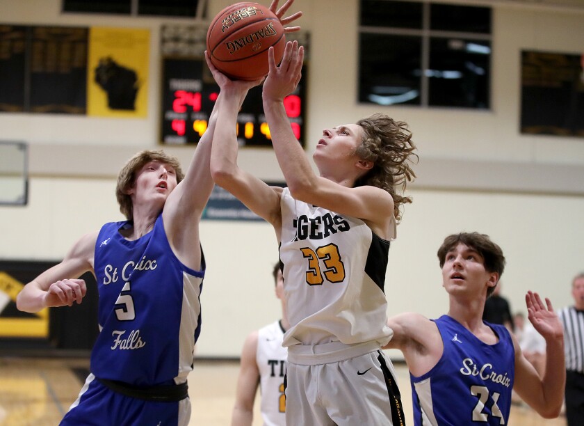 Northwestern’s Grady Gustafson (33) gets fouled by St. Croix Falls’ Brandon Waak (5)