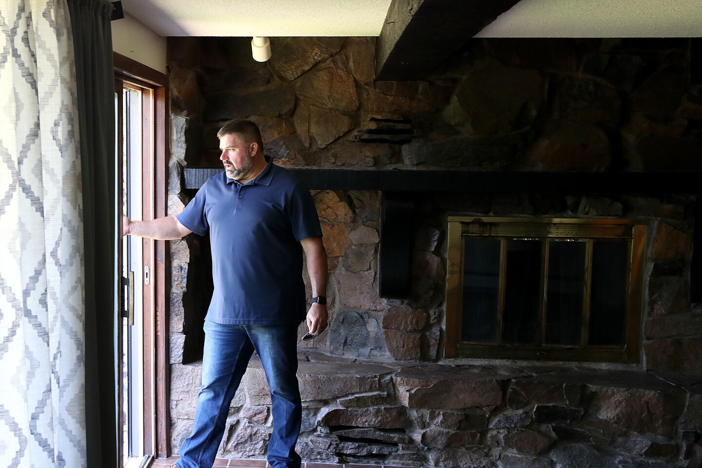 Man looks out door.