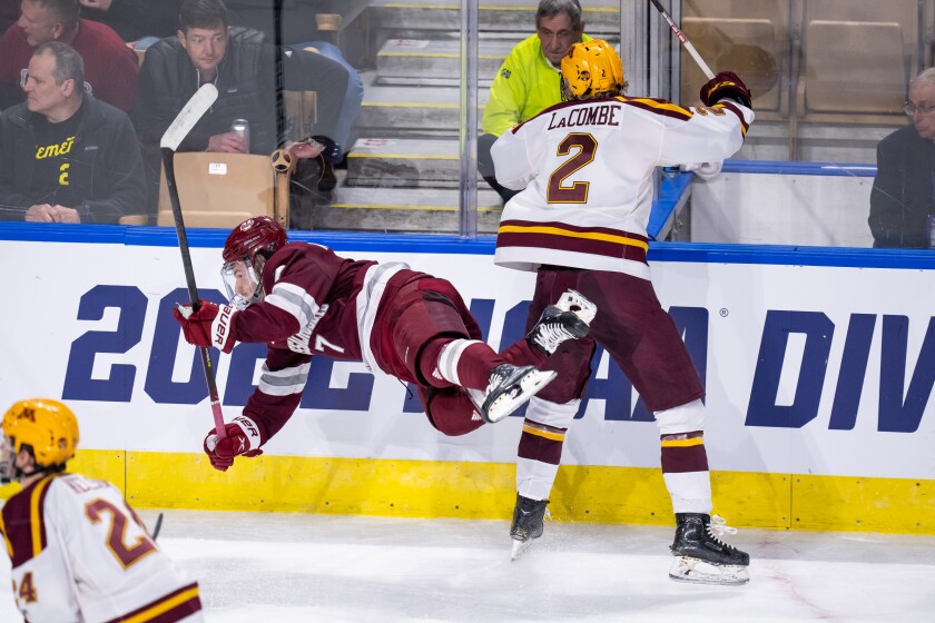 Minnesota's Jackson LaCombe checks Massachusetts player
