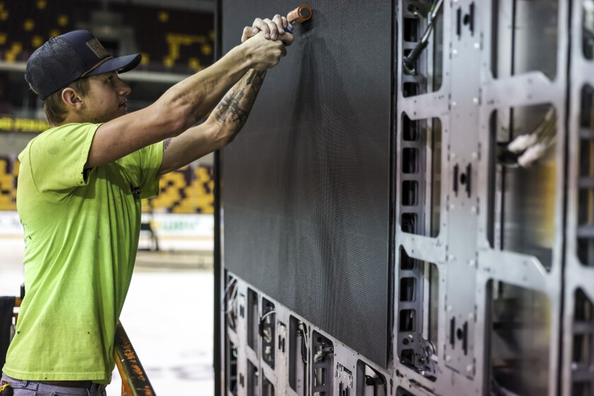 workers install new scoreboard