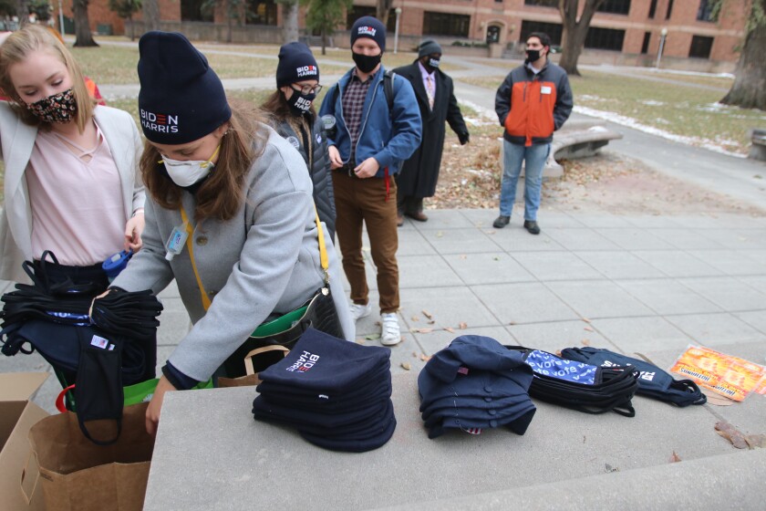 Biden team in Moorhead volunteer Grete Oanes passing out campaign paraphenalia to MSUM junior Jess Mueller and other students Thursday, Oct. 29.jpg