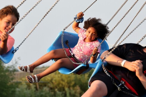Girls rides ride at fair.