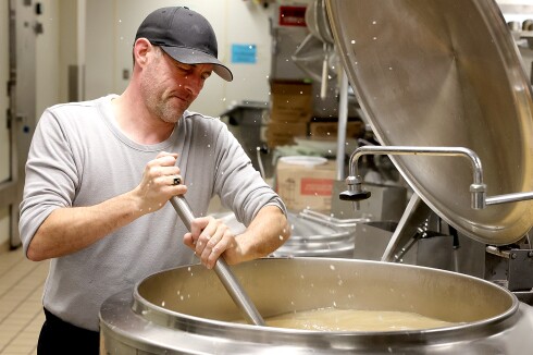 Man stirs gravy.