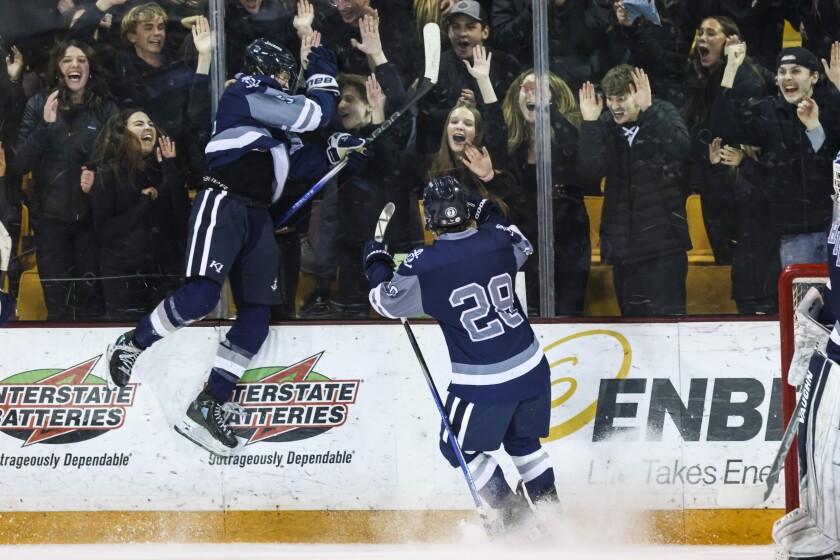 high school boys play ice hockey