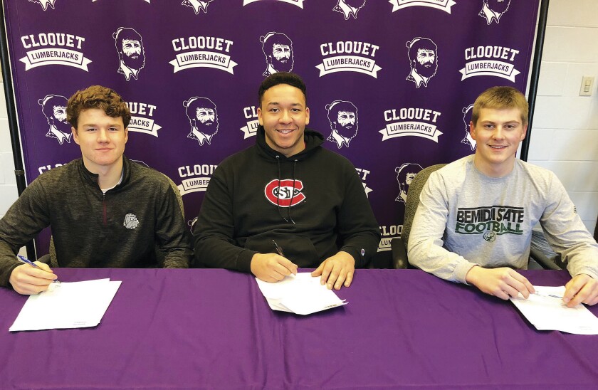 Three Cloquet High School seniors and football standouts signed commitment letters to play college football before school on Wednesday, Feb. 7, 2018. From left, Cloquet quarterback Tim Pokornowski committed to University of Minnesota Duluth, defensive tackle Dylan Lauer committed to St. Cloud State and running back Spencer Wehr committed to Bemidji State. Wednesday was the traditional National Signing Day.