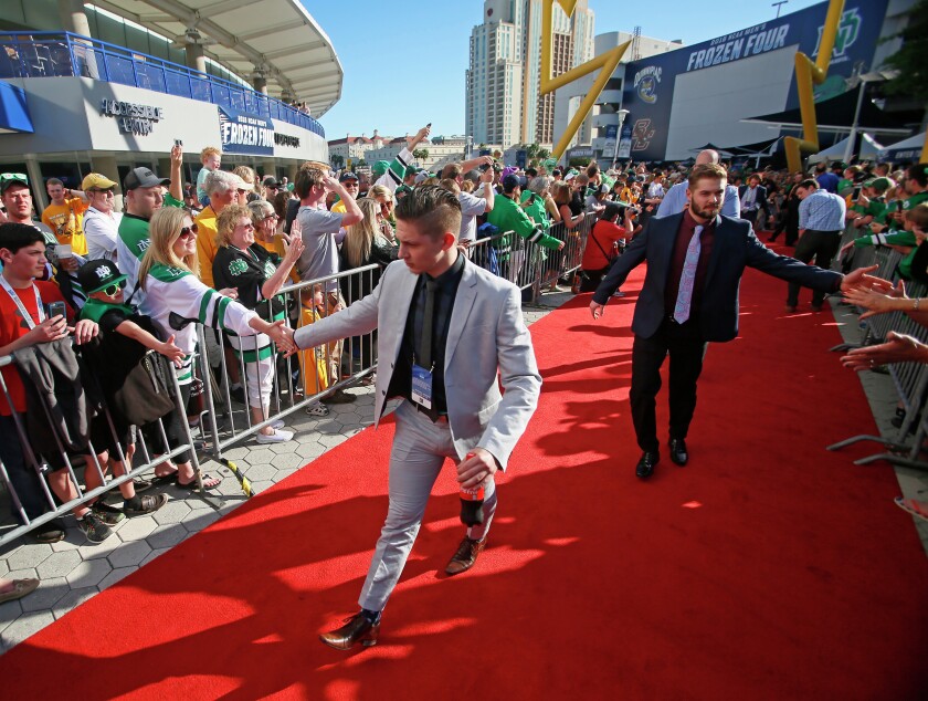 UND players Troy Stecher and Colten St. Clair greet fans as they walk the red carpet for the NCAA Frozen Four championship game at Amalie Arena in Tampa Bay, Fla. on Saturday, April 9, 2016.David Samson / The Forum