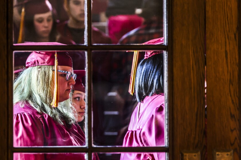 Student in maroon uniforms graduate