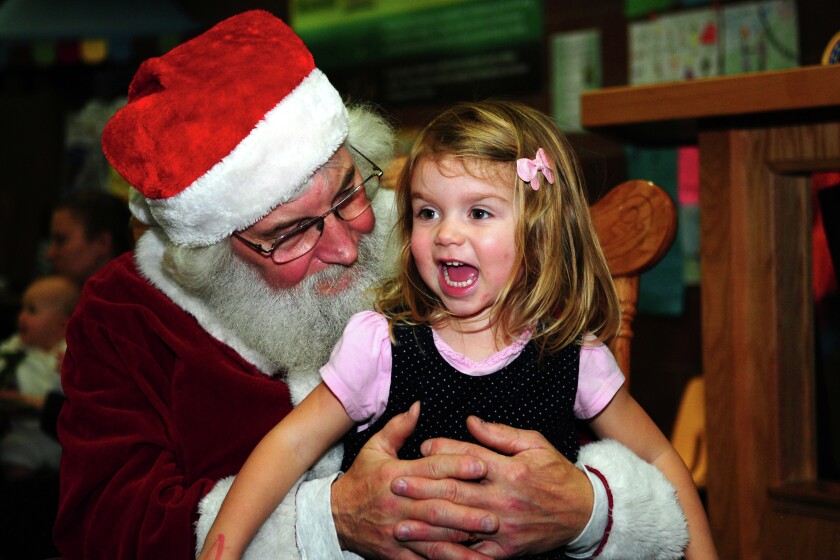 Santa listened to April Wolff’s requests at the Children’s Library in the Brainerd Library Monday after his reading of “Twas the Night Before Christmas”. Brainerd Dispatch/Steve Kohls
