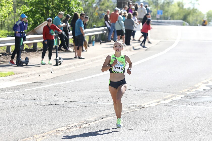 Women’s champion Dakotah Lindwurm is all smiles after crossing over the Lester River Bridge