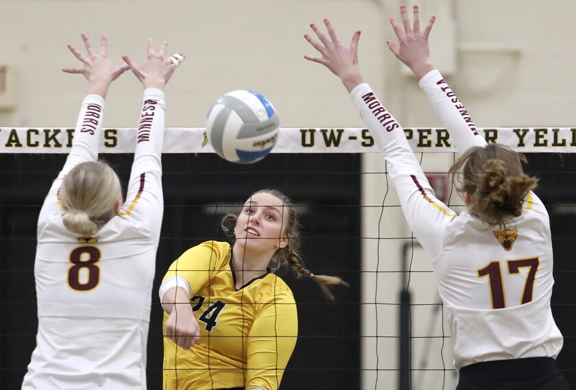 UW-Superior’s Kaylin Plautz (24) splits the Minnesota Morris block of Lydia Nash (8) and Maggie Jones (17)