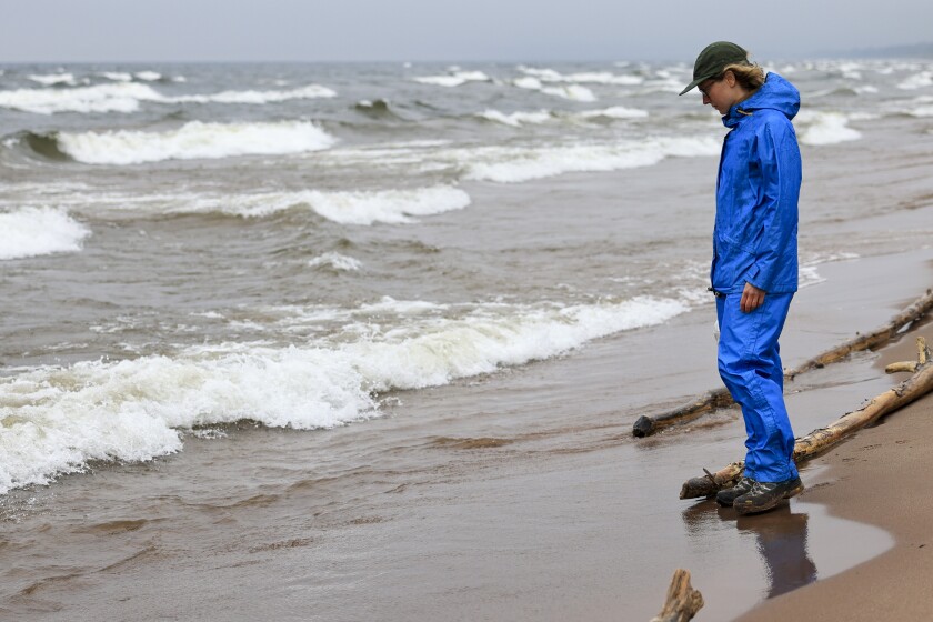 artist on Lake Superior beach unsettled cloudy rainy day