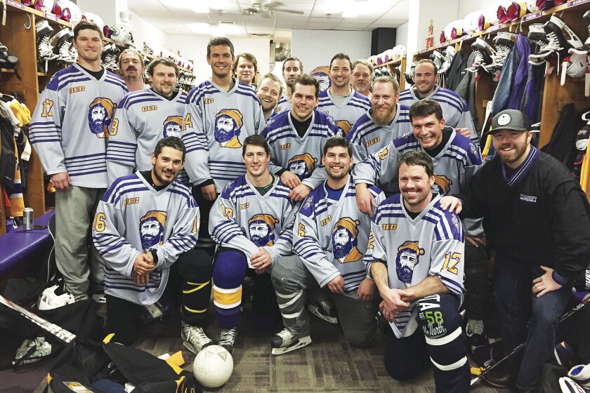 Members of the Cloquet-Esko-Carlton boys hockey alumni team pose in the locker room before the game against Duluth East. The team represents classes ranging from 1985 to 2011. Jamie Lund/Pine Journal