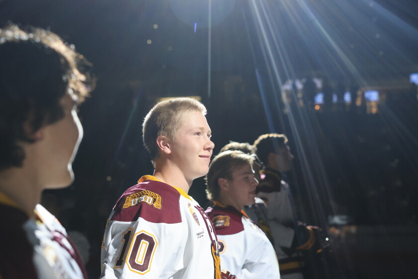 college men play ice hockey indoors