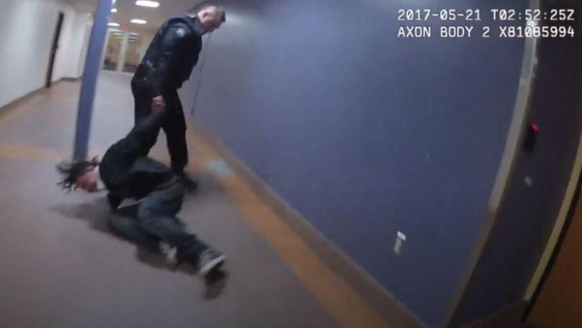 A screenshot from Duluth Police Department body camera footage shows Adam Huot dragging a man through the skywalk in downtown Duluth.