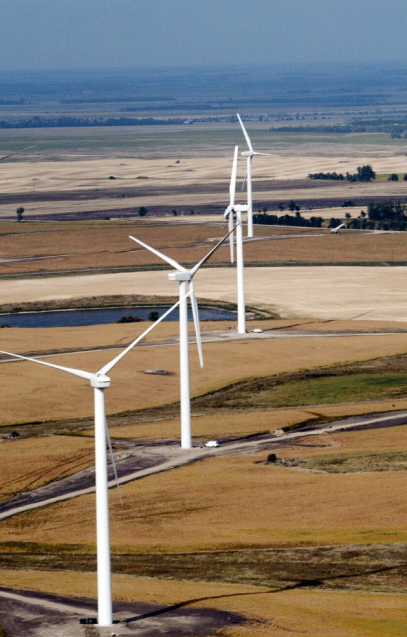 A row of wind turbines towers over the landscape near Edgeley, N.D. Darren Gibbins / Forum News Service